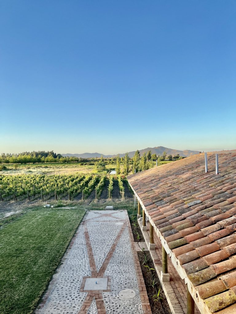 Vineyard and tiled roof at a Colonial-style home in Santa Ana, Colchagua Valley